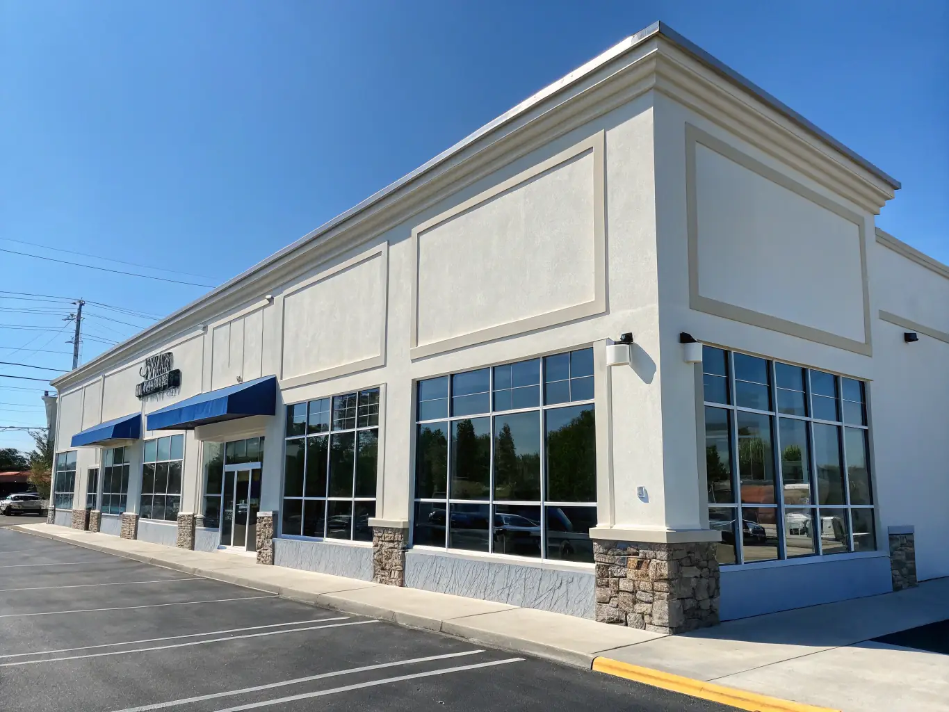 A commercial building with a spotless facade after power washing, highlighting the professional appearance maintained by Stuffy’s Handyman Services.