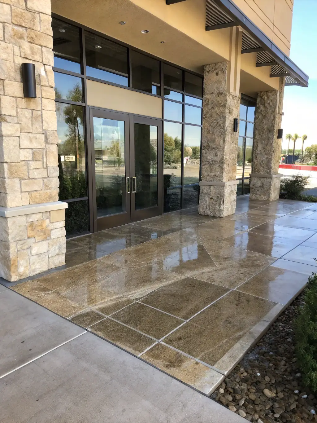 A commercial storefront in Houston, TX, being power washed, with a focus on the clean, inviting entrance.